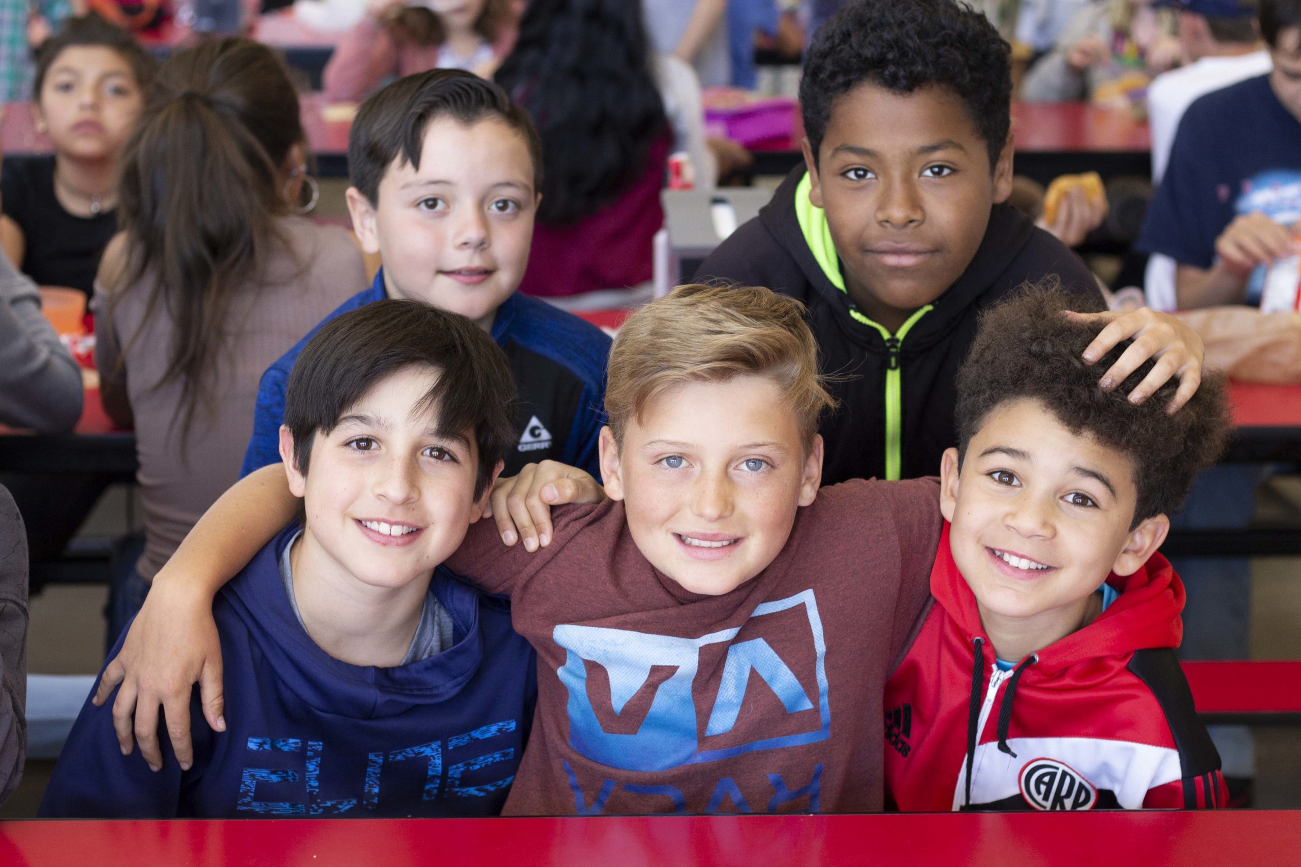 Five young students smiling